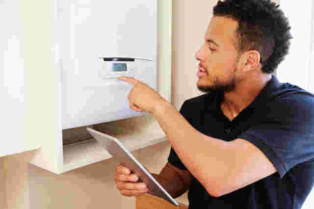 An installer fitting a boiler